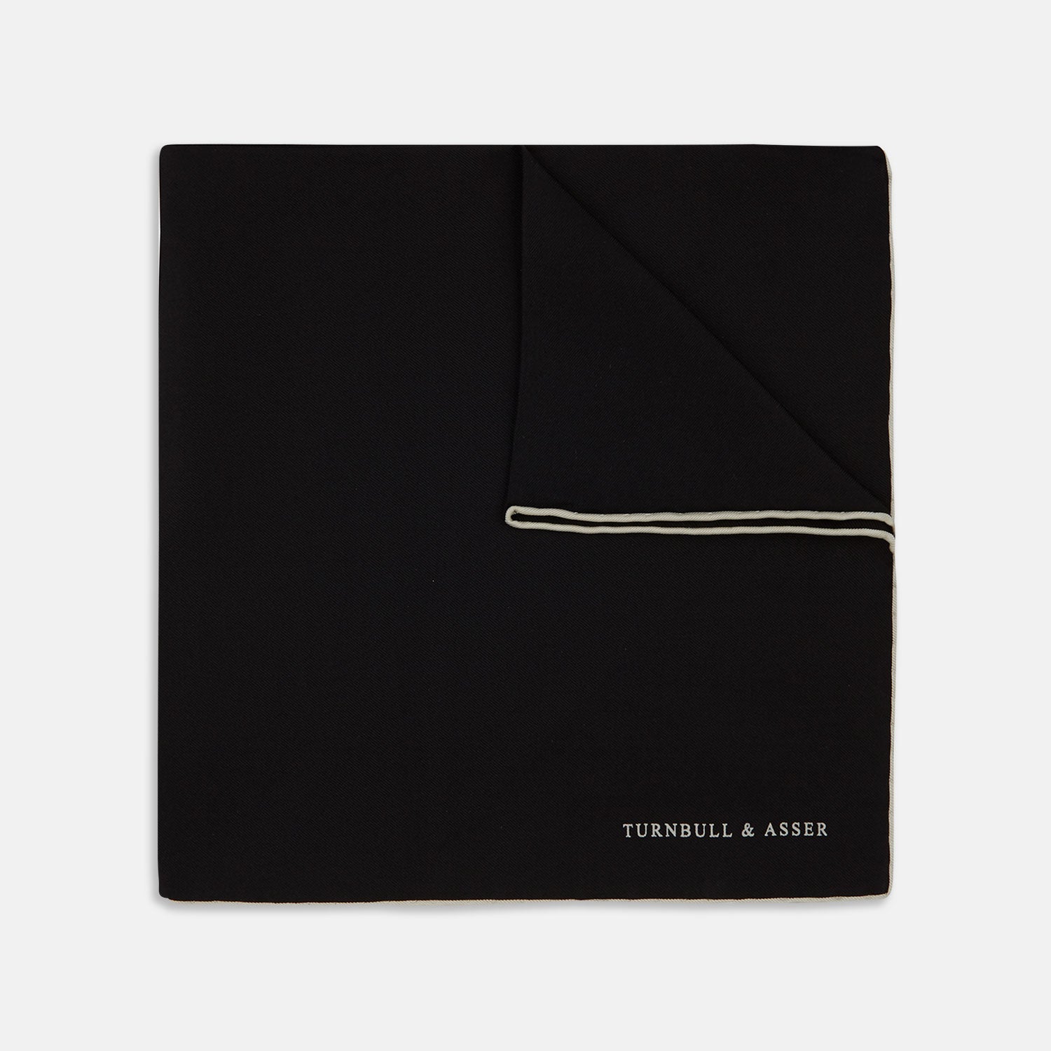 View 1 of product Add a touch of elegance with Turnbull & Asser’s Black and White Piped Silk Pocket Square, featuring white piping on one edge and the brand’s embroidered logo in white for a refined, classic look.