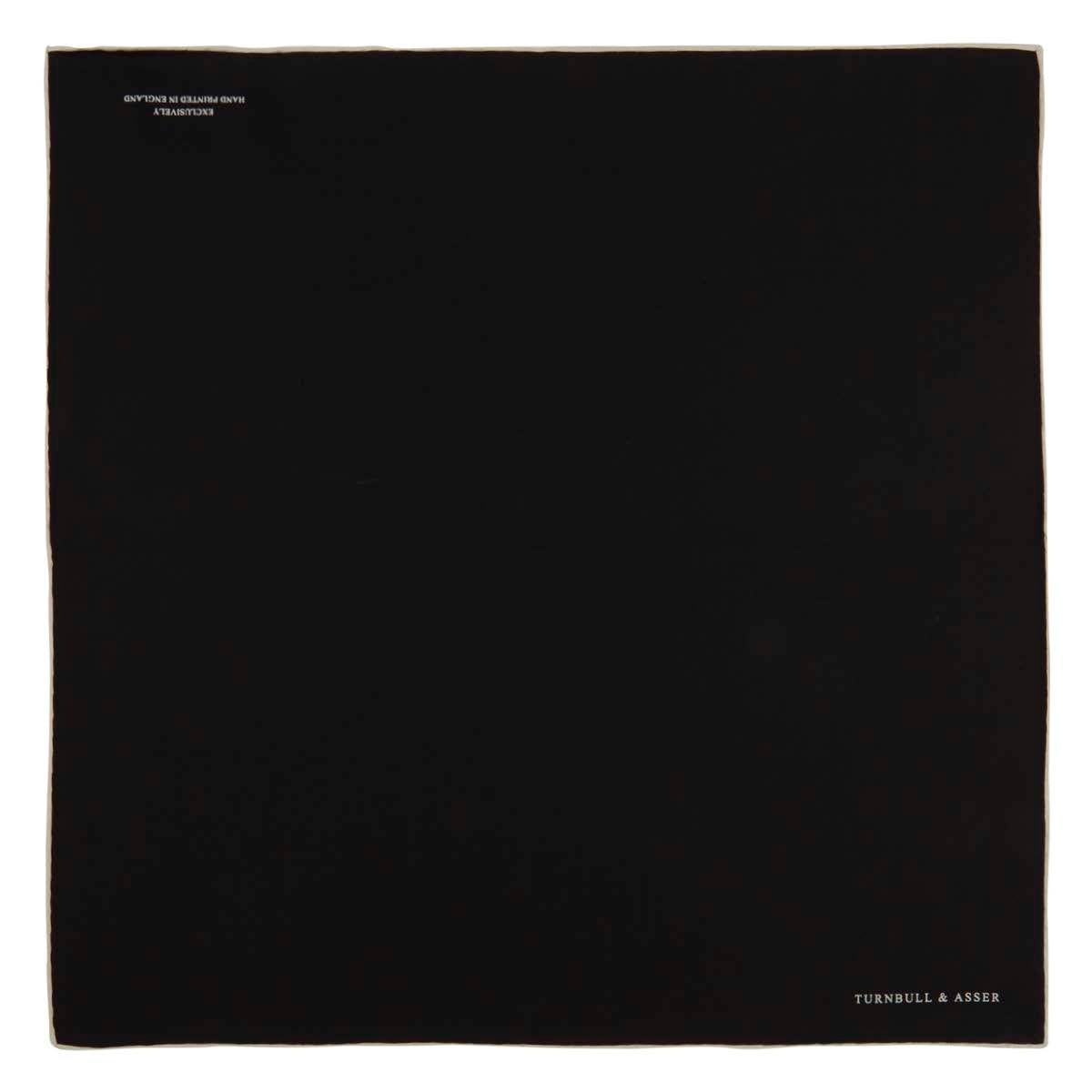 View 2 of product Add a touch of elegance with Turnbull & Asser’s Black and White Piped Silk Pocket Square, featuring white piping on one edge and the brand’s embroidered logo in white for a refined, classic look.