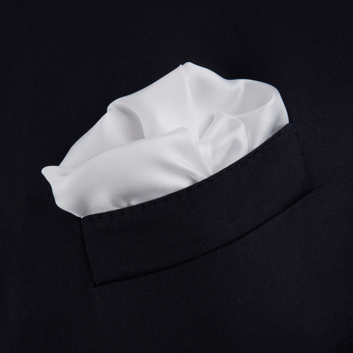 View 4 of product The Turnbull & Asser White and Black Piped Silk Pocket Square features a crisp white base with black edging, neatly folded to showcase the logo in black on the lower right—elegant monochrome style for any occasion, shown on a light gray background.