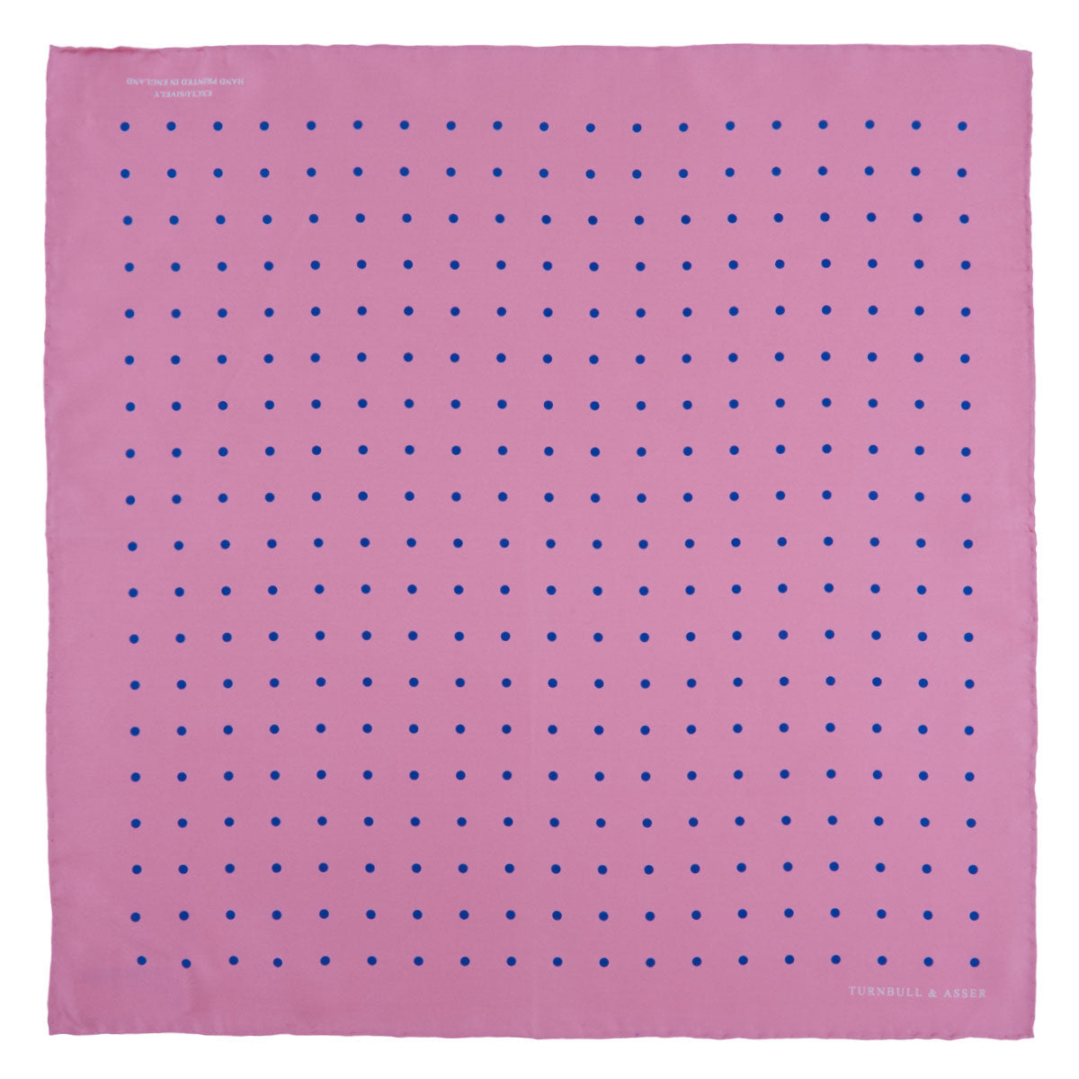 View 2 of product The Turnbull & Asser Rose and Blue Spot Silk Pocket Square features a pastel pink base with evenly spaced blue spots and a discreet white logo in one corner, finished with a slightly folded top for added flair.