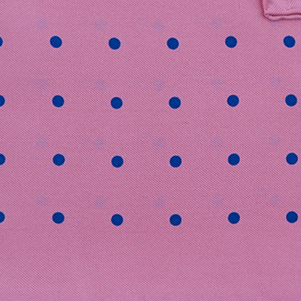 The Turnbull & Asser Rose and Blue Spot Silk Pocket Square features a pastel pink base with evenly spaced blue spots and a discreet white logo in one corner, finished with a slightly folded top for added flair.