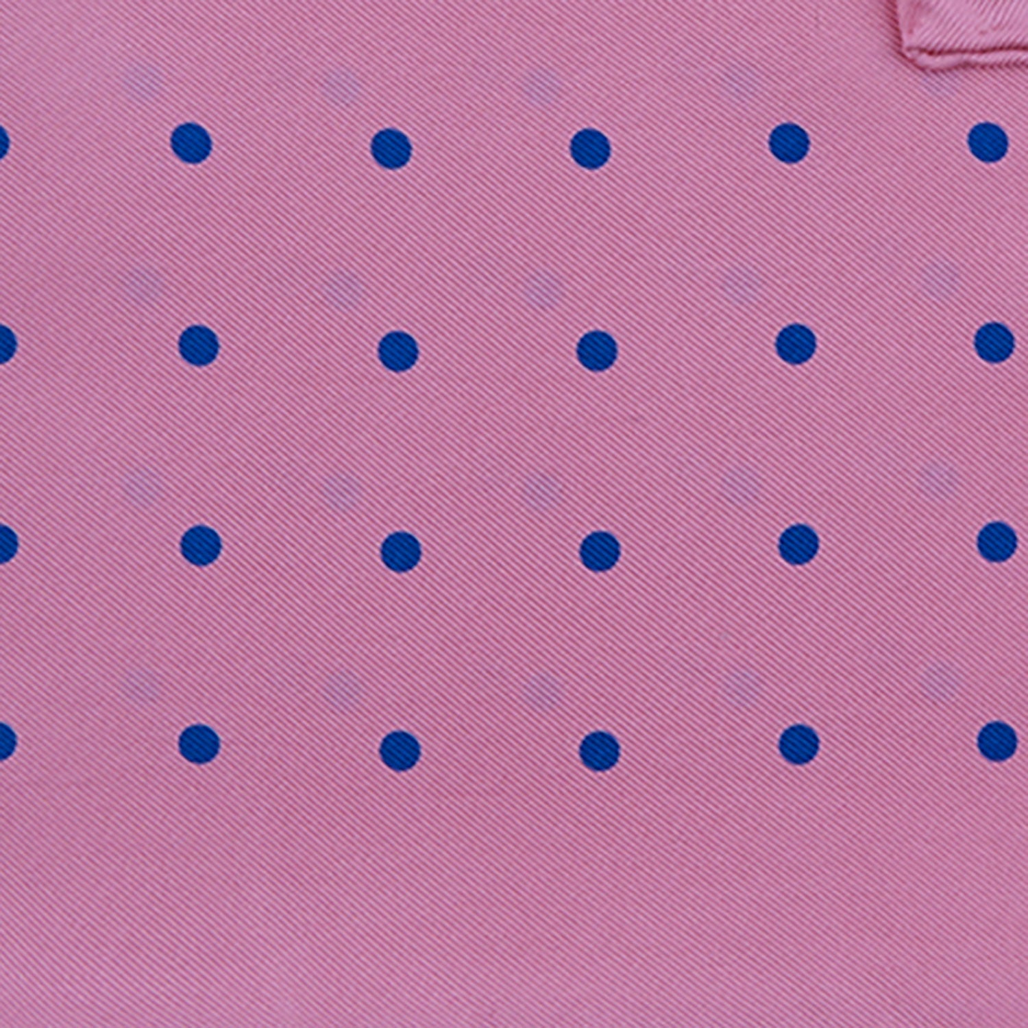 View 3 of product The Turnbull & Asser Rose and Blue Spot Silk Pocket Square features a pastel pink base with evenly spaced blue spots and a discreet white logo in one corner, finished with a slightly folded top for added flair.