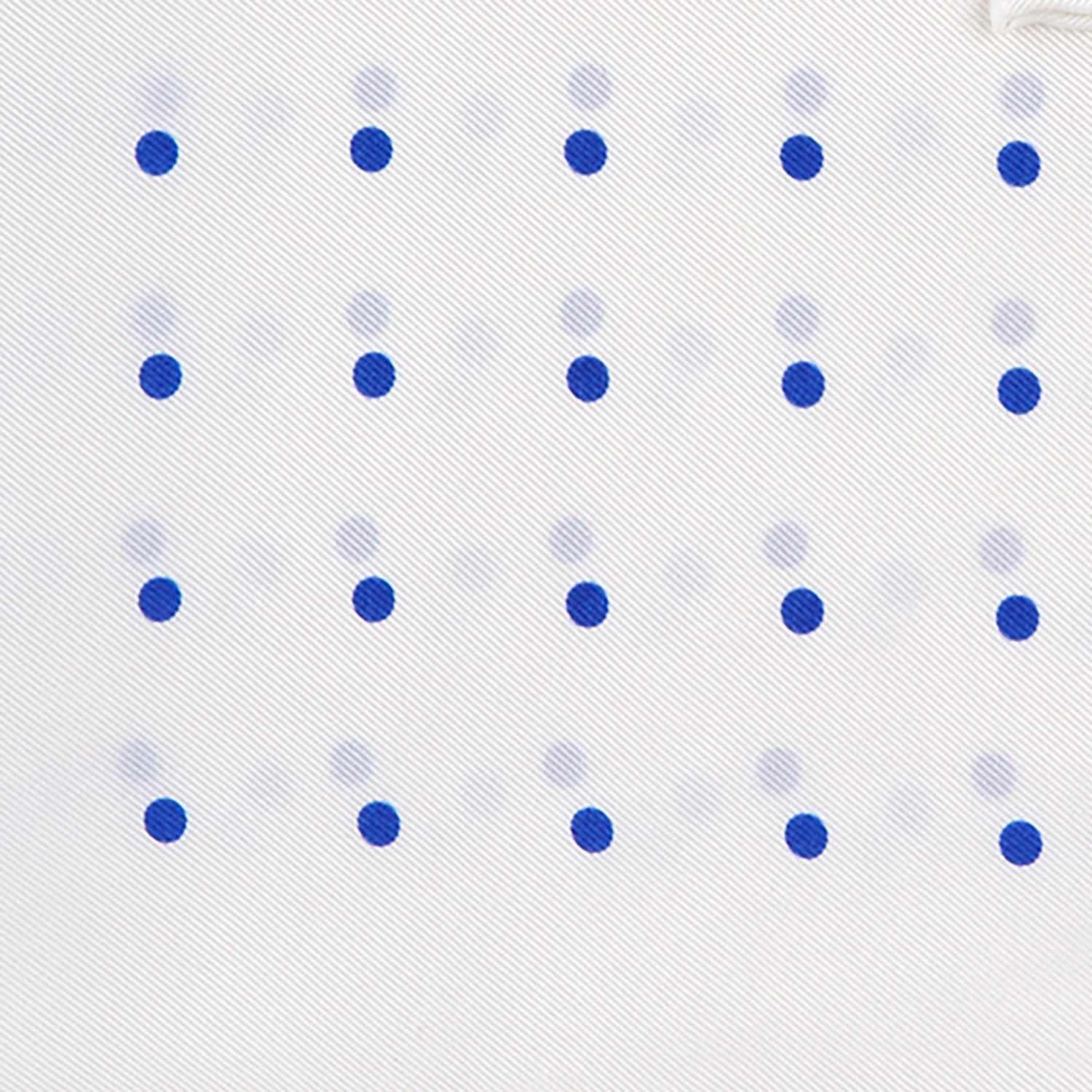 View 3 of product The Turnbull & Asser White and Blue Spot Silk Pocket Square features evenly spaced blue dots, a brand logo in one corner, and is displayed on a light blue background with a stylishly folded corner.