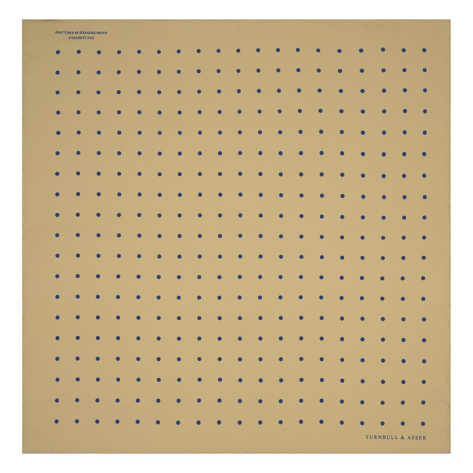 View 2 of product The Yellow and Blue Spot Silk Pocket Square by Turnbull & Asser features evenly spaced blue dots on yellow silk, with the brand name printed in one corner and a refined folded finish.
