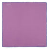 View 2 of product The Lilac and Navy Piped Silk Pocket Square by Turnbull & Asser features a folded lilac design with dark blue trim and the brand's name printed in white in the lower right corner.
