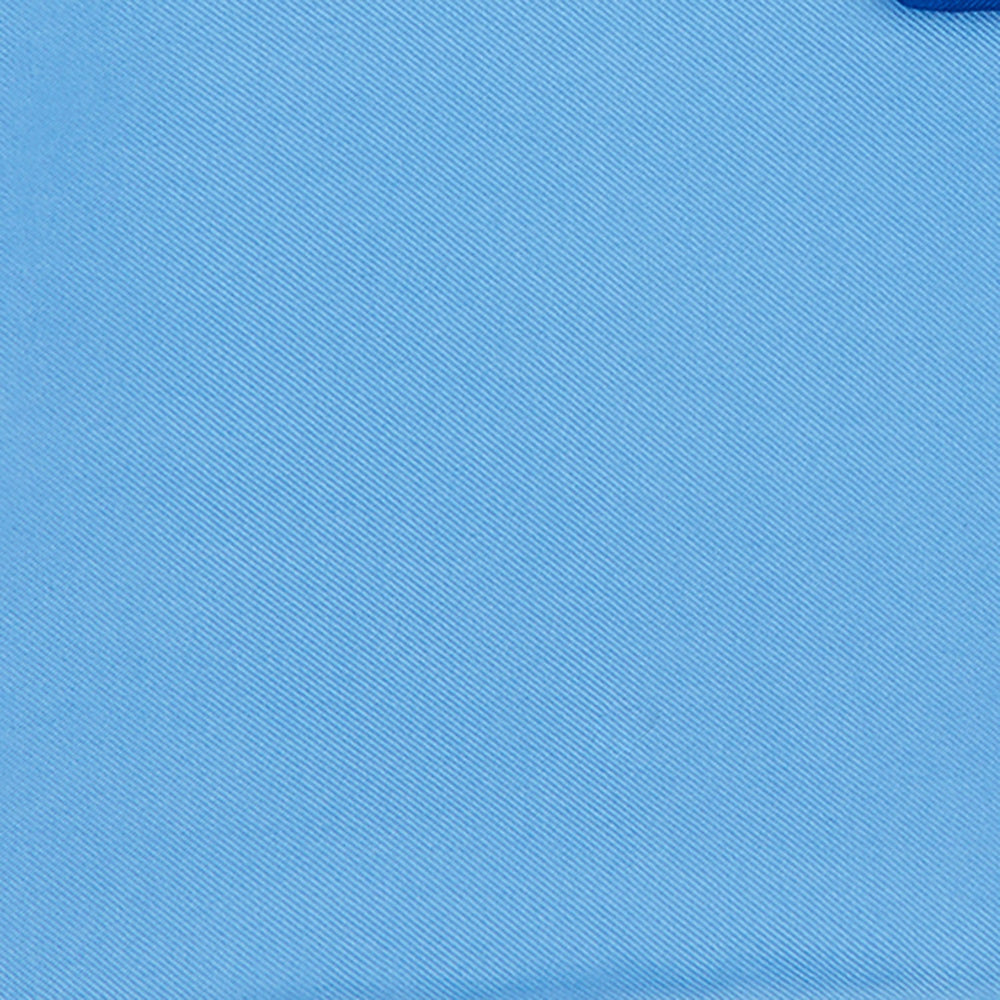 The Light Blue and Navy Piped Silk Pocket Square by Turnbull & Asser, neatly folded with dark blue edges and the brand’s white logo in the corner, is shown on a plain white background—a refined accessory for any occasion.