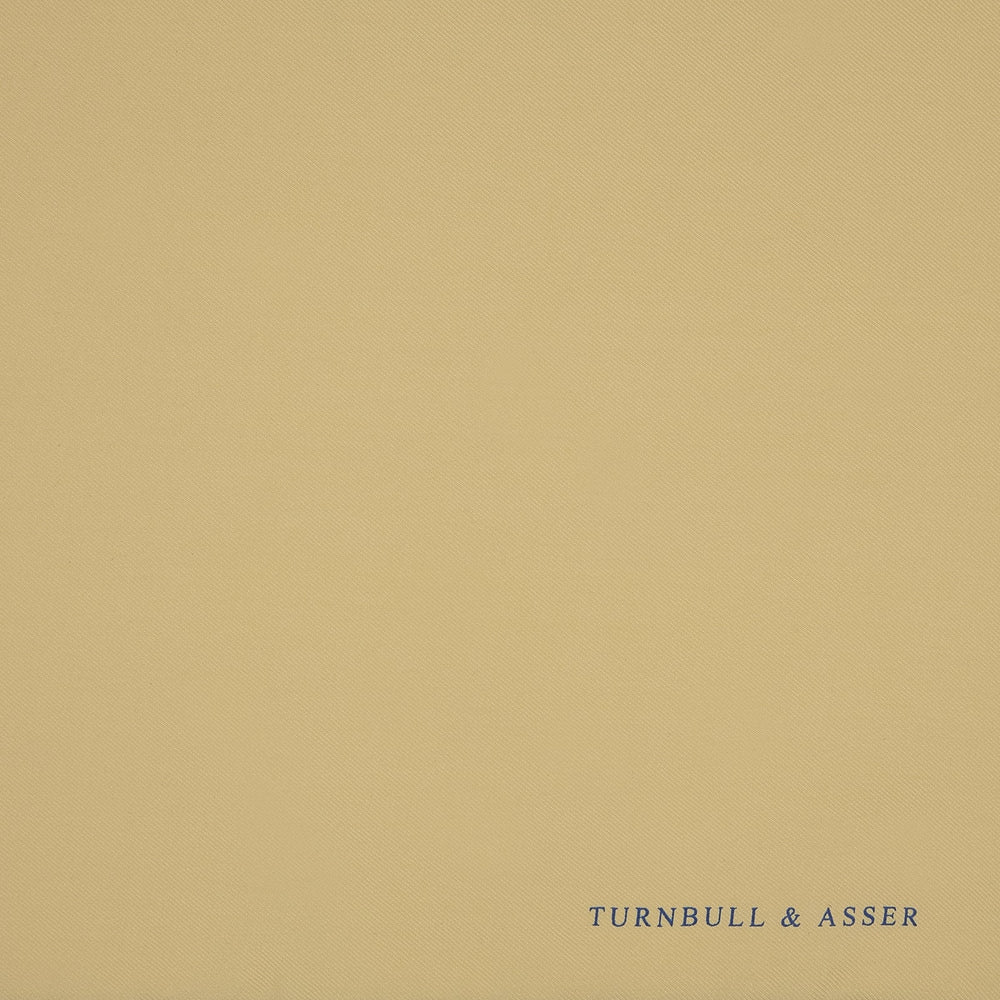 The Yellow and Navy Piped Silk Pocket Square by Turnbull & Asser features blue piping and the brand’s logo in blue on yellow silk—an elegant accessory for any outfit.