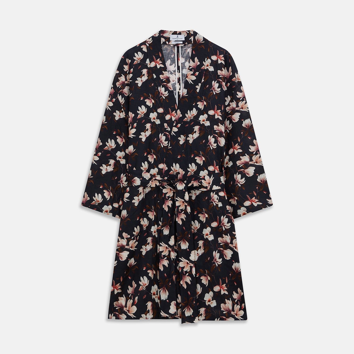 View 1 of product The Turnbull & Asser Navy Floral Pattern Linen Hayhurt Kimono Gown is a knee-length, long-sleeved gown with a floral print and a matching fabric belt tied at the waist.