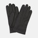 The Walden Black Leather Gloves by Turnbull & Asser, crafted from hairsheep leather with decorative stitching, are shown overlapping on a white background—an elegant showcase of timeless luxury and refined style.