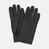 View 1 of product Turnbull & Asser Black Kirkdale Leather Gloves, featuring textured black leather and a sleek wrist strap with a small buckle detail, are displayed on a white background.