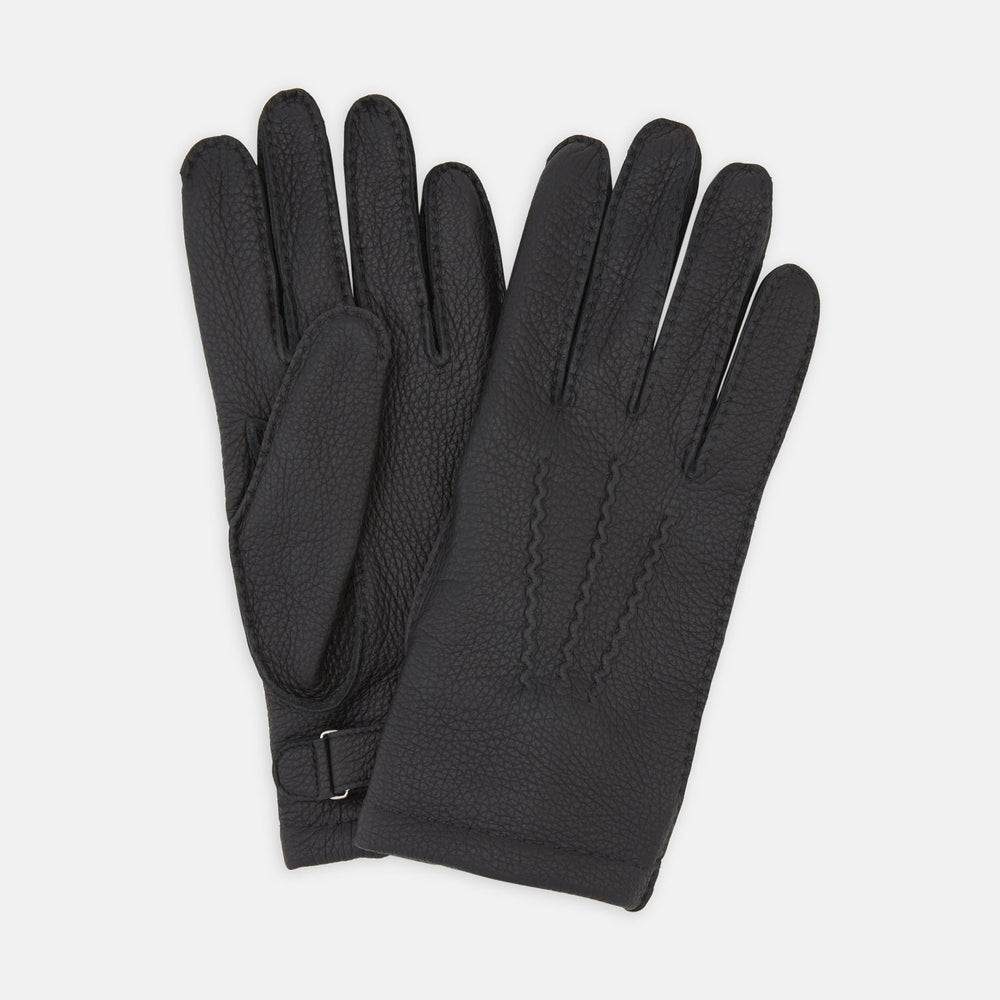 Turnbull & Asser Black Kirkdale Leather Gloves, featuring textured black leather and a sleek wrist strap with a small buckle detail, are displayed on a white background.