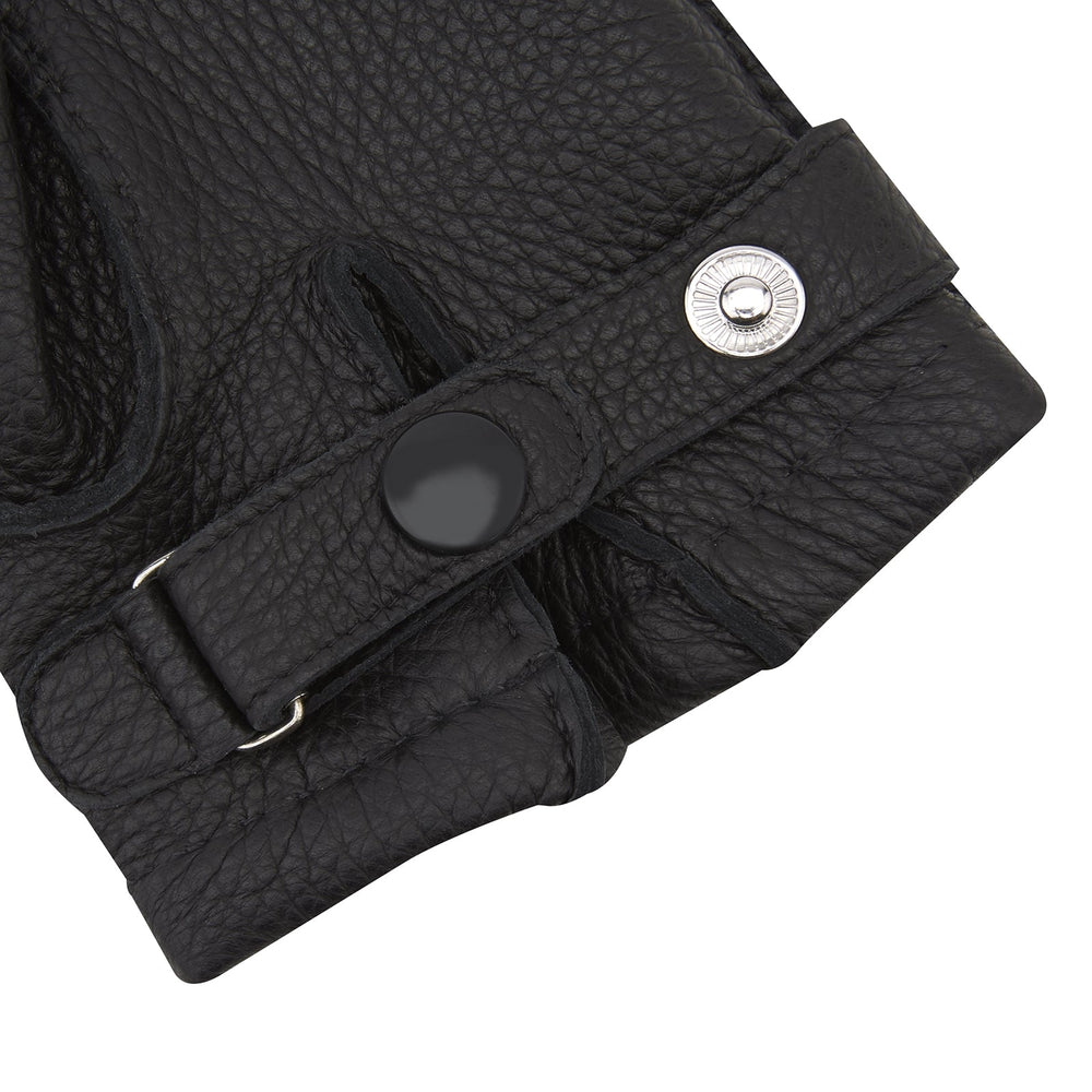 Turnbull & Asser Black Kirkdale Leather Gloves, featuring textured black leather and a sleek wrist strap with a small buckle detail, are displayed on a white background.