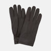View 1 of product Turnbull & Asser Dark Brown Kirkdale Leather Gloves, shown on a white background, feature a textured leather finish, decorative stitching on the back, and an adjustable wrist strap.