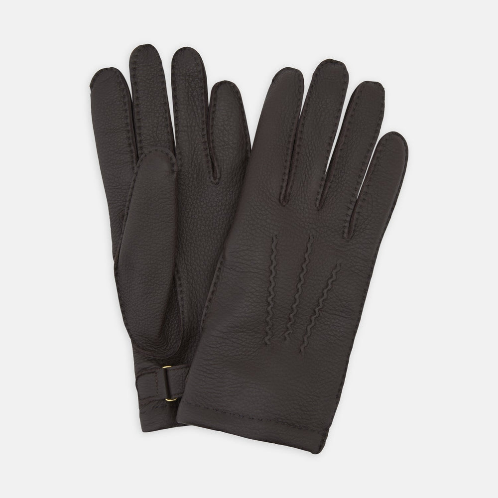 Turnbull & Asser Dark Brown Kirkdale Leather Gloves, shown on a white background, feature a textured leather finish, decorative stitching on the back, and an adjustable wrist strap.