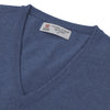 View 2 of product The Turnbull & Asser Blue V-Neck Cashmere Slipover, neatly folded with the label visible, is crafted from soft cashmere and ideal for formal layering. Shown against a white background.