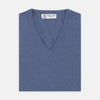 View 1 of product The Turnbull & Asser Blue V-Neck Cashmere Slipover, neatly folded with the label visible, is crafted from soft cashmere and ideal for formal layering. Shown against a white background.