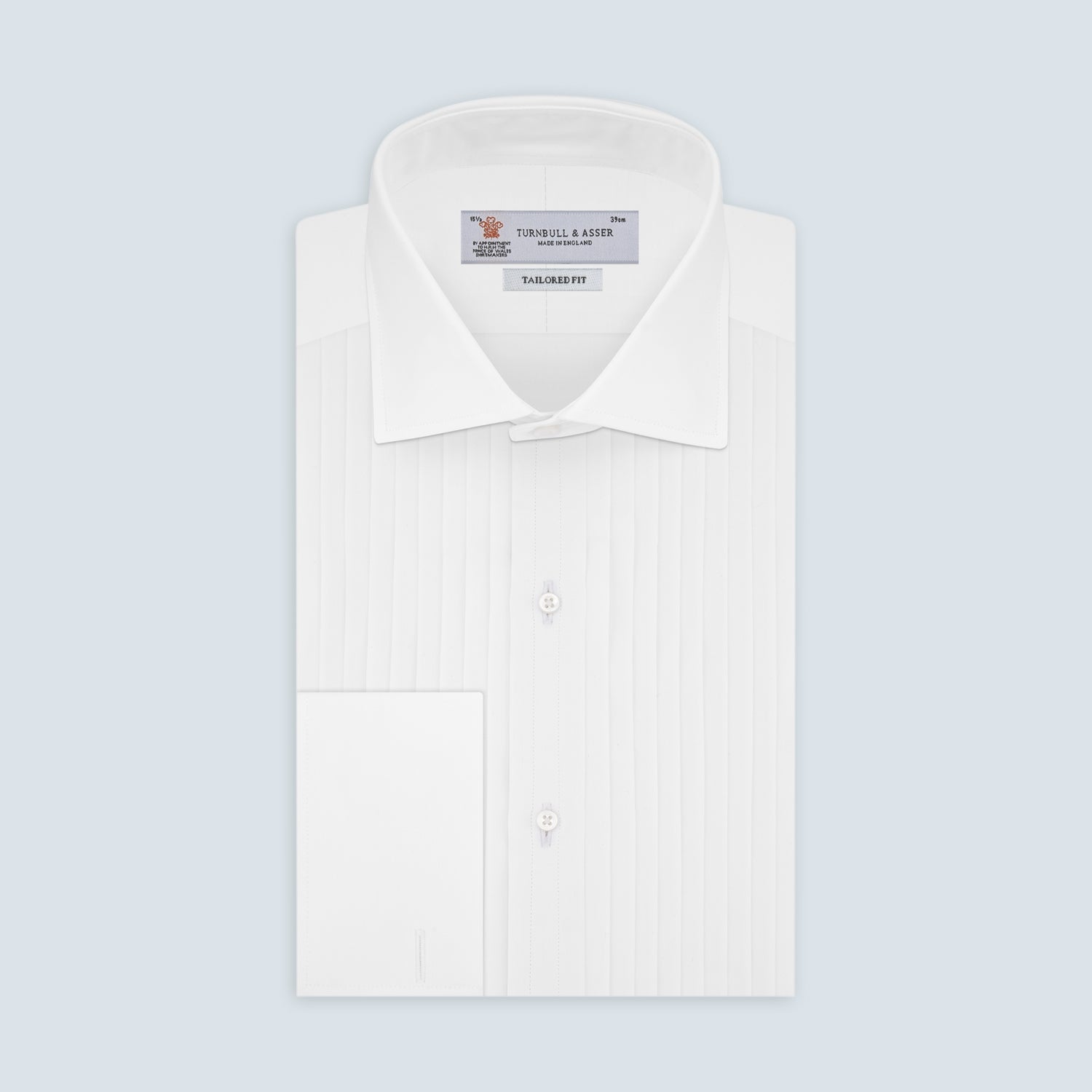 View 1 of product The Tailored Fit White Pleated Front Shirt with Kent Collar and Double Cuffs by Turnbull & Asser is neatly folded and buttoned up, shown on a light grey background—a classic black tie shirt option.