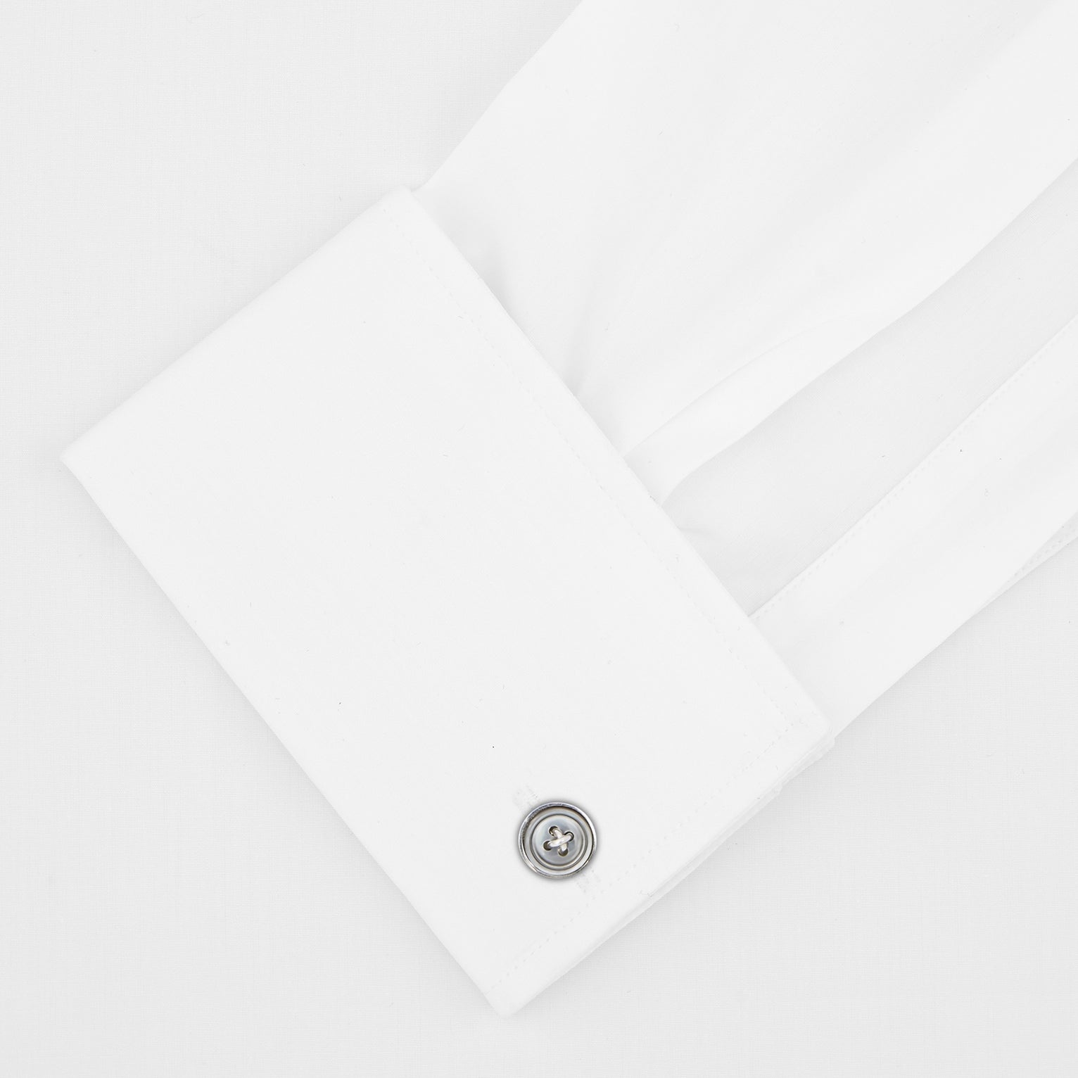 View 2 of product The Tailored Fit White Pleated Front Shirt with Kent Collar and Double Cuffs by Turnbull & Asser is neatly folded and buttoned up, shown on a light grey background—a classic black tie shirt option.