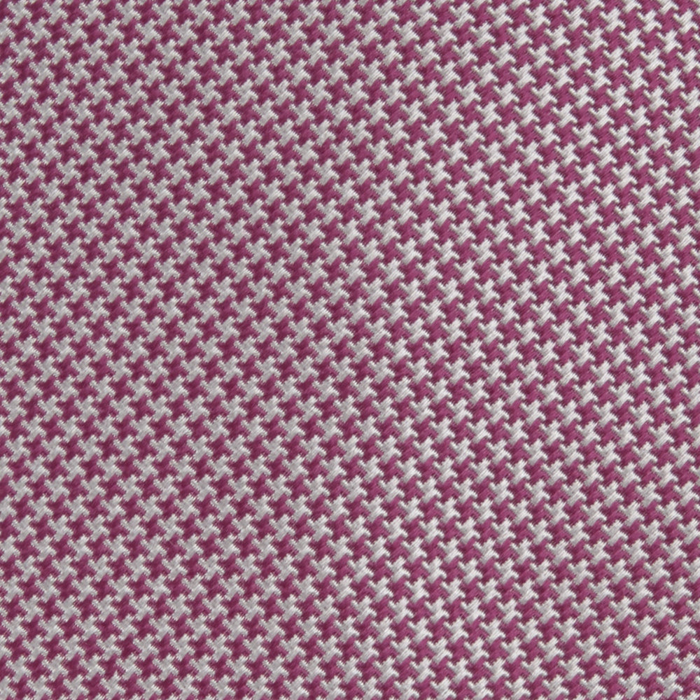 The Turnbull & Asser Dark Pink Houndstooth Silk Tie is rolled up and displayed on a plain white background.