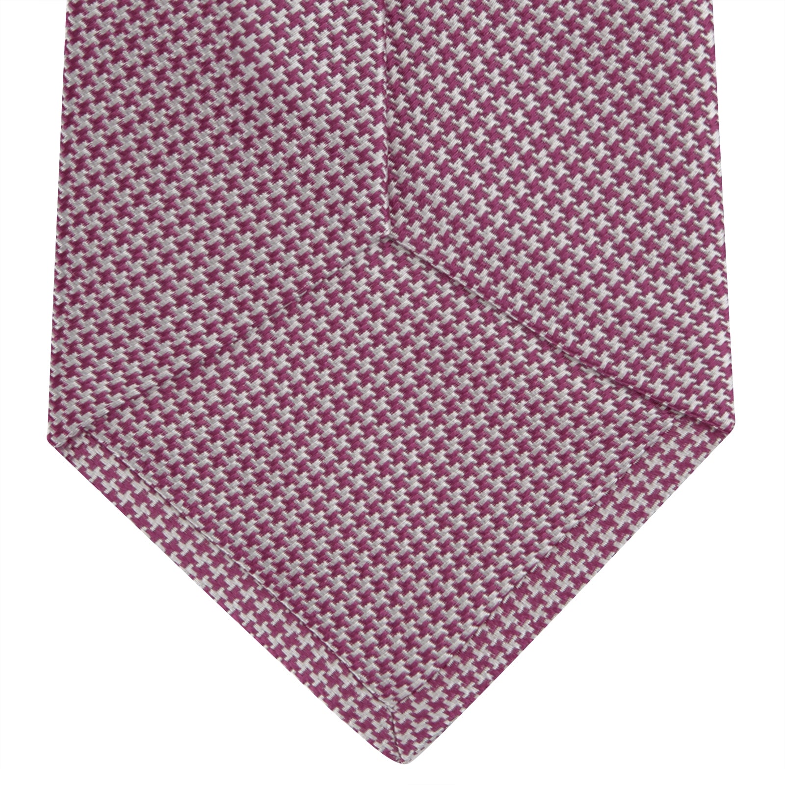 View 4 of product The Turnbull & Asser Dark Pink Houndstooth Silk Tie is rolled up and displayed on a plain white background.