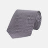 View 1 of product The Plum Houndstooth Silk Tie by Turnbull & Asser features a refined small black, white, and gray pattern—perfect as an office shirt accessory—shown rolled up on a plain white background.