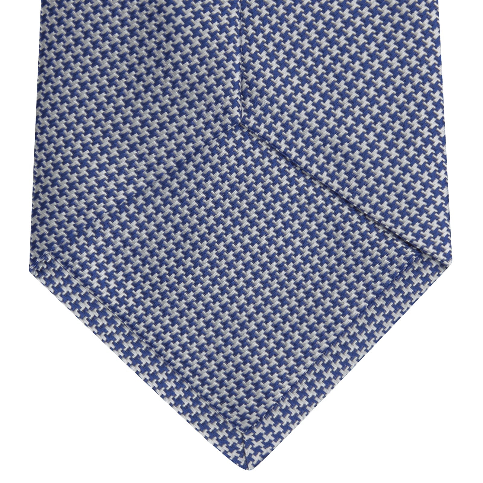 View 4 of product The Turnbull & Asser Blue Houndstooth Silk Tie features a classic blue and white pattern, rolled and displayed on a white background—an elegant accessory for your favorite office shirt.