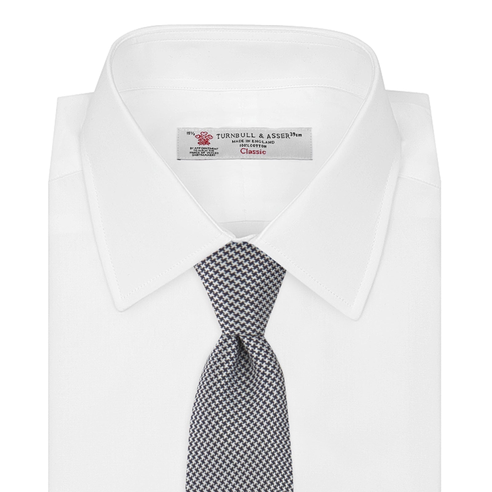 View 2 of product The Turnbull & Asser Navy Houndstooth Silk Tie features a refined small houndstooth pattern in navy, elegantly rolled and showcased on a white background.