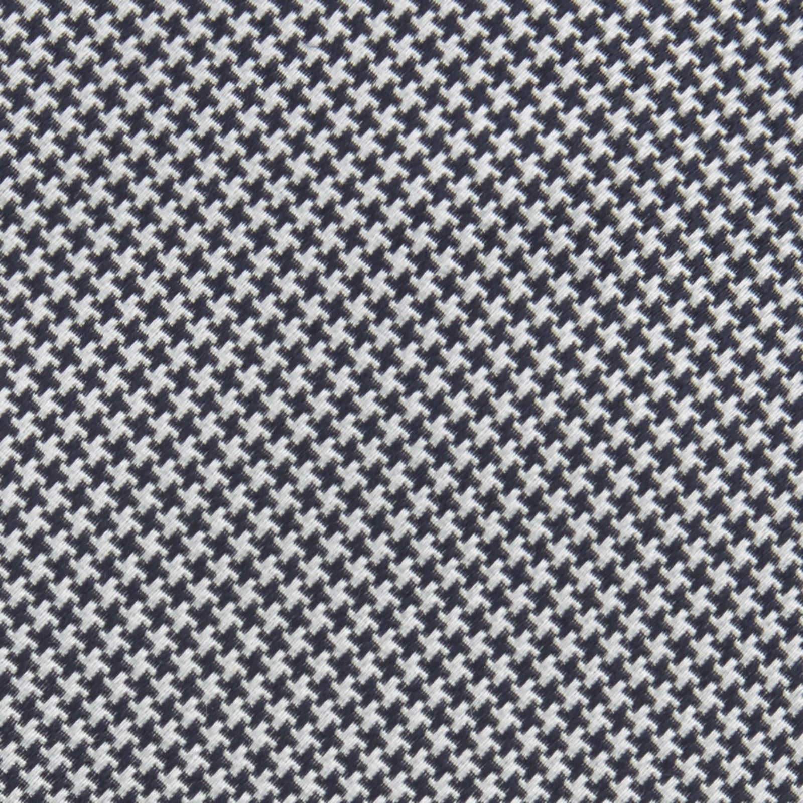 View 3 of product The Turnbull & Asser Navy Houndstooth Silk Tie features a refined small houndstooth pattern in navy, elegantly rolled and showcased on a white background.