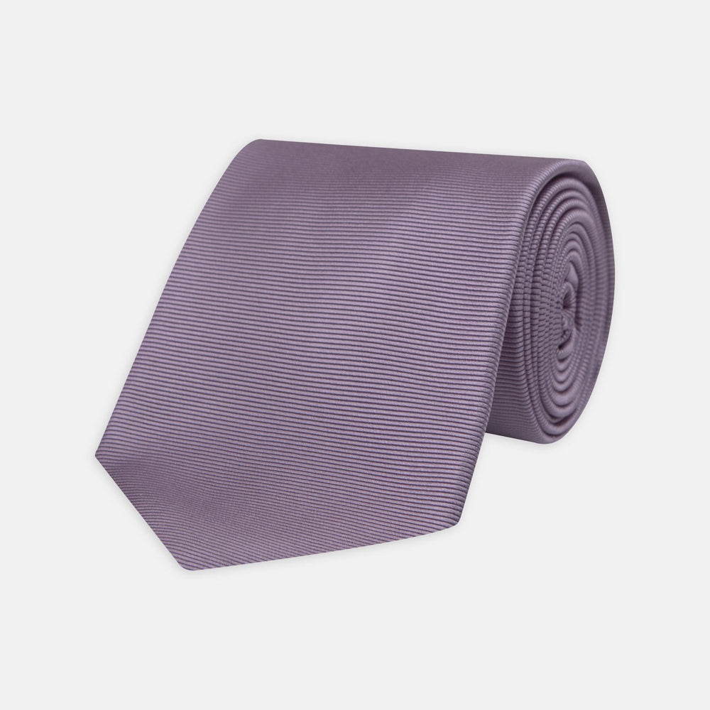 The Lilac Horizontal Twill Silk Tie by Turnbull & Asser features a subtle ribbed texture and neat roll, shown on a white background—an ideal accessory for any cotton shirt.