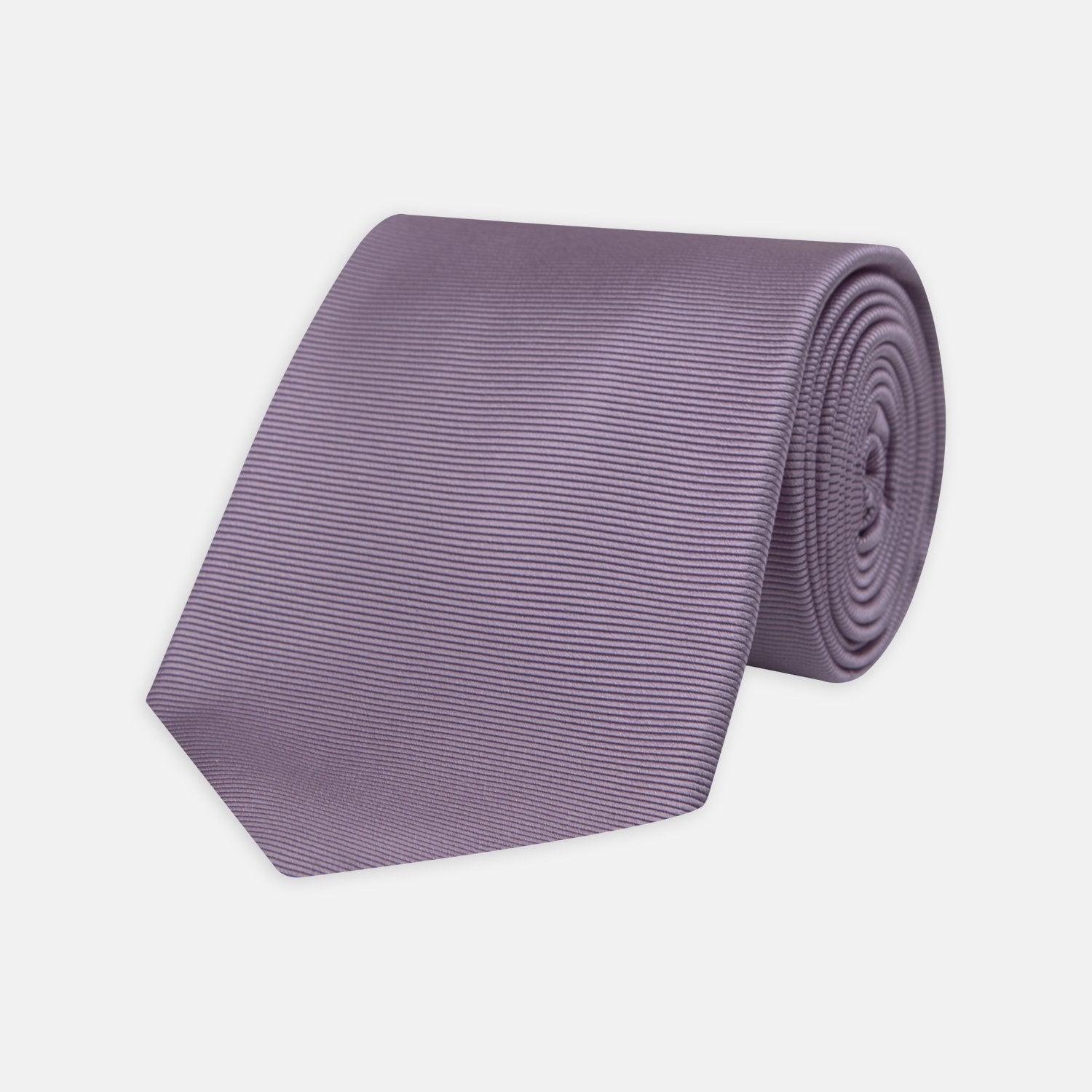 View 1 of product The Lilac Horizontal Twill Silk Tie by Turnbull & Asser features a subtle ribbed texture and neat roll, shown on a white background—an ideal accessory for any cotton shirt.