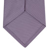 View 4 of product The Lilac Horizontal Twill Silk Tie by Turnbull & Asser features a subtle ribbed texture and neat roll, shown on a white background—an ideal accessory for any cotton shirt.