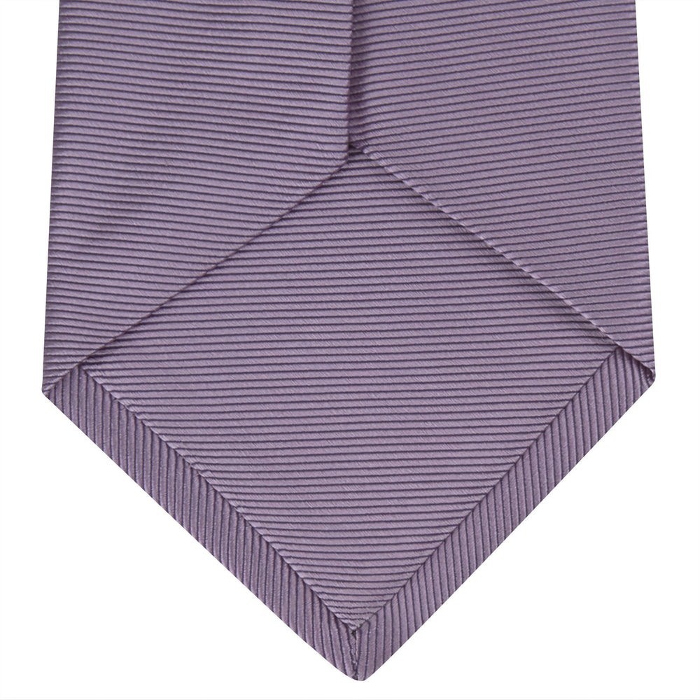 The Lilac Horizontal Twill Silk Tie by Turnbull & Asser features a subtle ribbed texture and neat roll, shown on a white background—an ideal accessory for any cotton shirt.