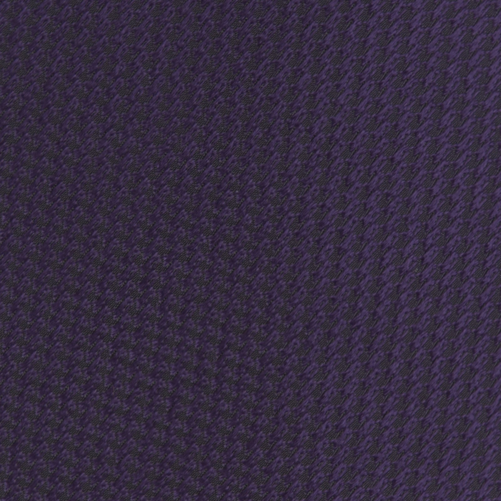View 3 of product The Turnbull & Asser Plum Lace Silk Tie features a neatly rolled, dark purple design with a textured finish, displayed on a plain white background.