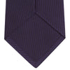 View 4 of product The Turnbull & Asser Plum Lace Silk Tie features a neatly rolled, dark purple design with a textured finish, displayed on a plain white background.