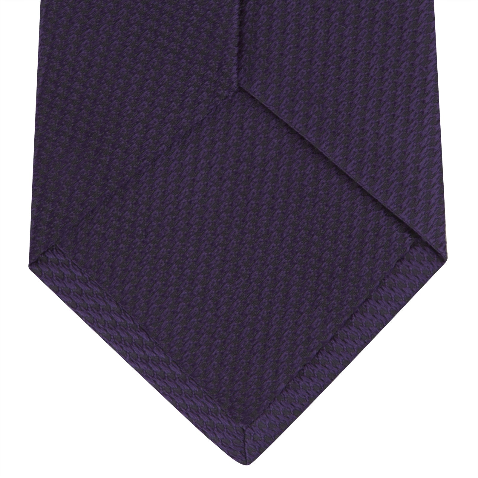 View 4 of product The Turnbull & Asser Plum Lace Silk Tie features a neatly rolled, dark purple design with a textured finish, displayed on a plain white background.