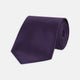 The Turnbull & Asser Plum Plain Satin Silk Tie, shown rolled up on a white background, highlights its classic and versatile style for any occasion.