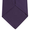 View 4 of product The Turnbull & Asser Plum Plain Satin Silk Tie, shown rolled up on a white background, highlights its classic and versatile style for any occasion.