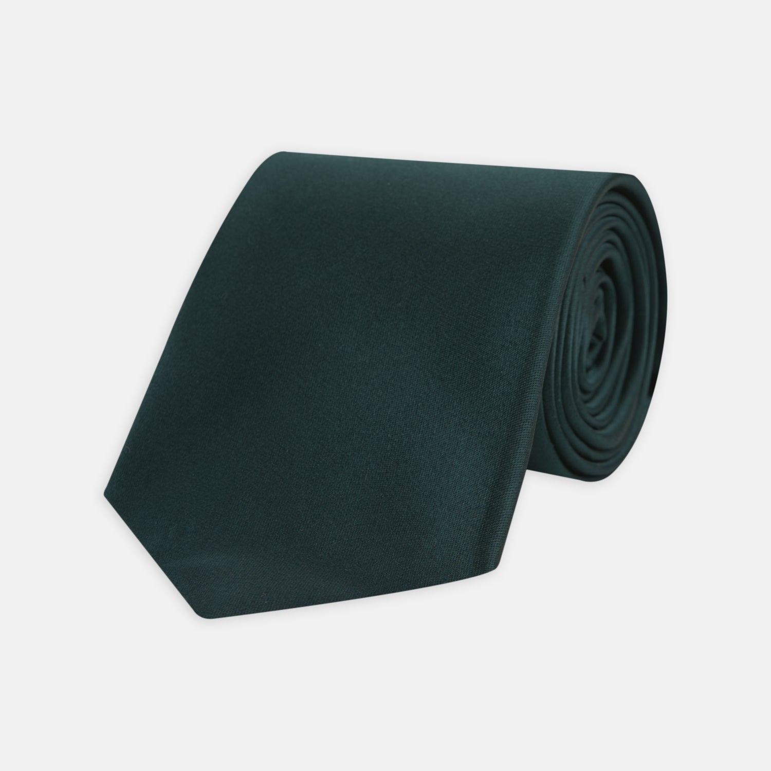 View 1 of product The Turnbull & Asser Forest Green Plain Satin Silk Tie, neatly rolled with a pointed end, is displayed on a plain white background.