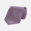 View 1 of product The Turnbull & Asser Lilac Plain Satin Silk Tie, featuring a smooth finish, is neatly rolled and displayed on a white background—a classic accessory for any versatile wardrobe.