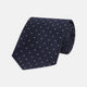 The Turnbull & Asser Navy and Rose Spot Lace Silk Tie features a rolled-up navy design with delicate rose spots, ideal for adding elegance to any office shirt, shown against a plain white background.