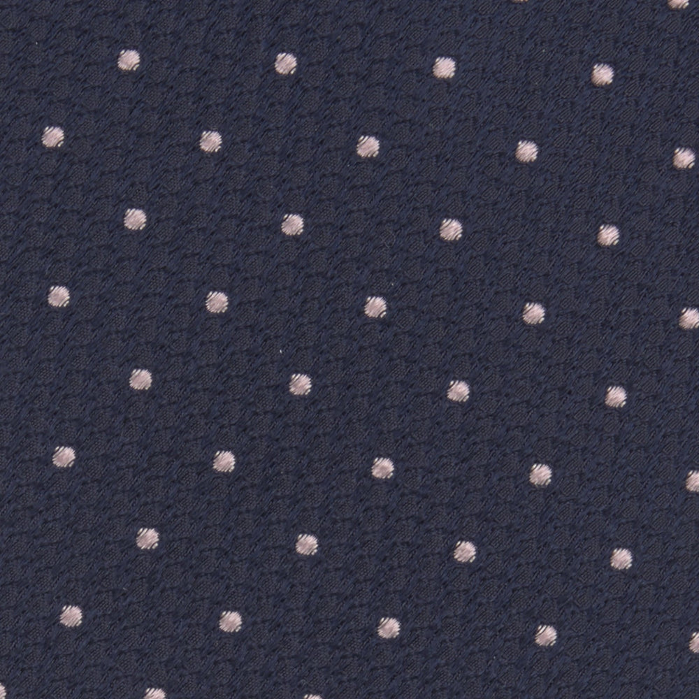 The Turnbull & Asser Navy and Rose Spot Lace Silk Tie features a rolled-up navy design with delicate rose spots, ideal for adding elegance to any office shirt, shown against a plain white background.