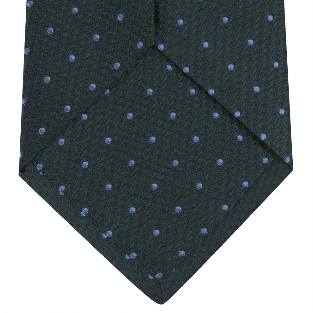 The Turnbull & Asser Forest Green and Blue Spot Lace Silk Tie features small blue dots on green silk—an elegant accessory to complement your favorite office shirt.