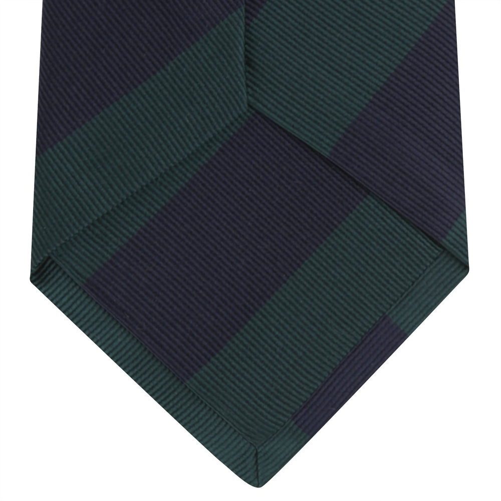 The Turnbull & Asser Navy and Forest Green Block Stripe Repp Silk Tie features bold stripes and is expertly crafted from luxurious silk, shown rolled on a white background.