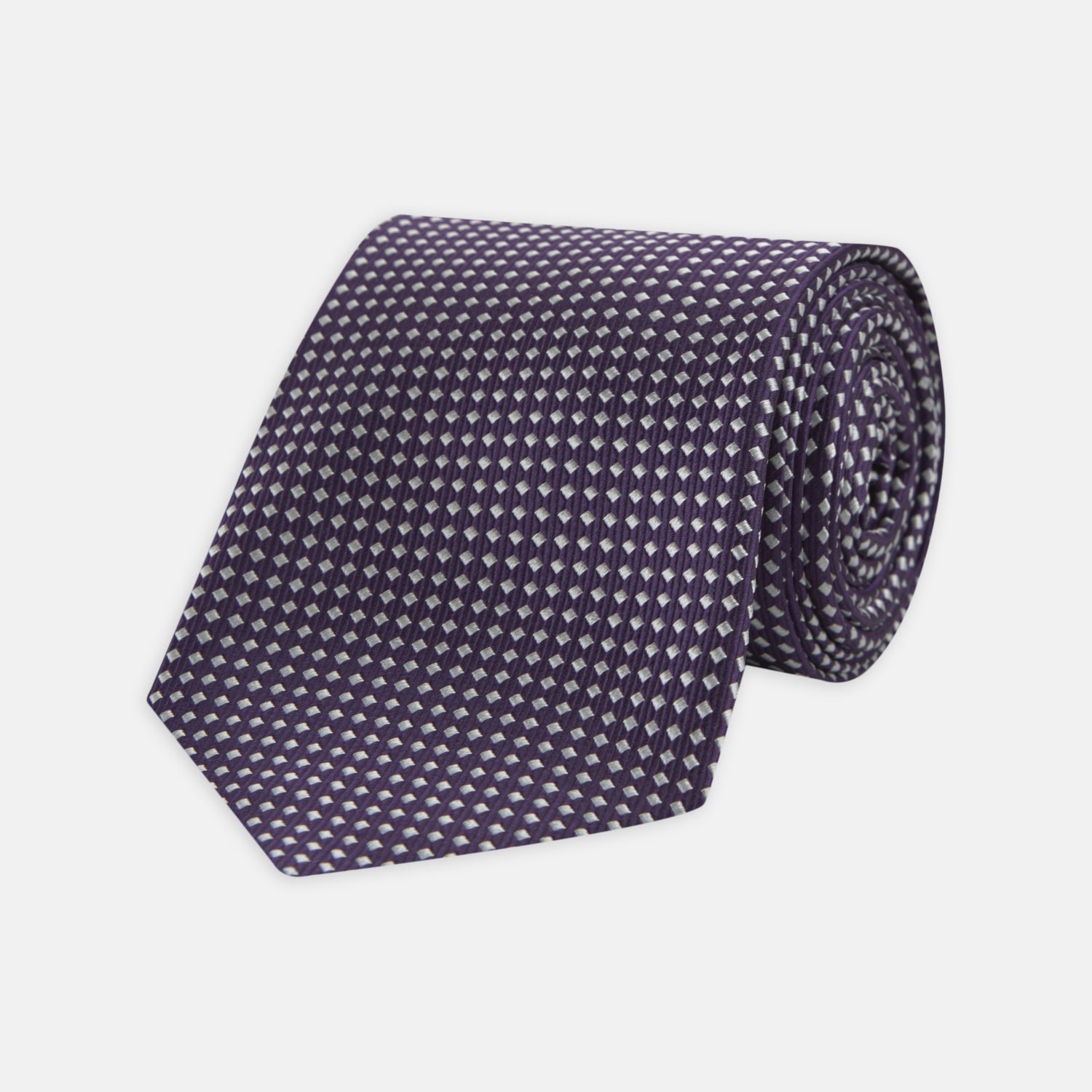 View 1 of product The Turnbull & Asser Plum and White Diamond Silk Tie features a subtle repeating pattern, shown rolled up on a white background—a timeless accessory to elevate any office shirt.