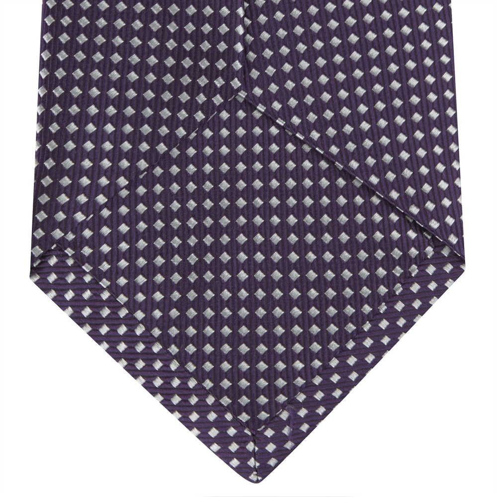 The Turnbull & Asser Plum and White Diamond Silk Tie features a subtle repeating pattern, shown rolled up on a white background—a timeless accessory to elevate any office shirt.