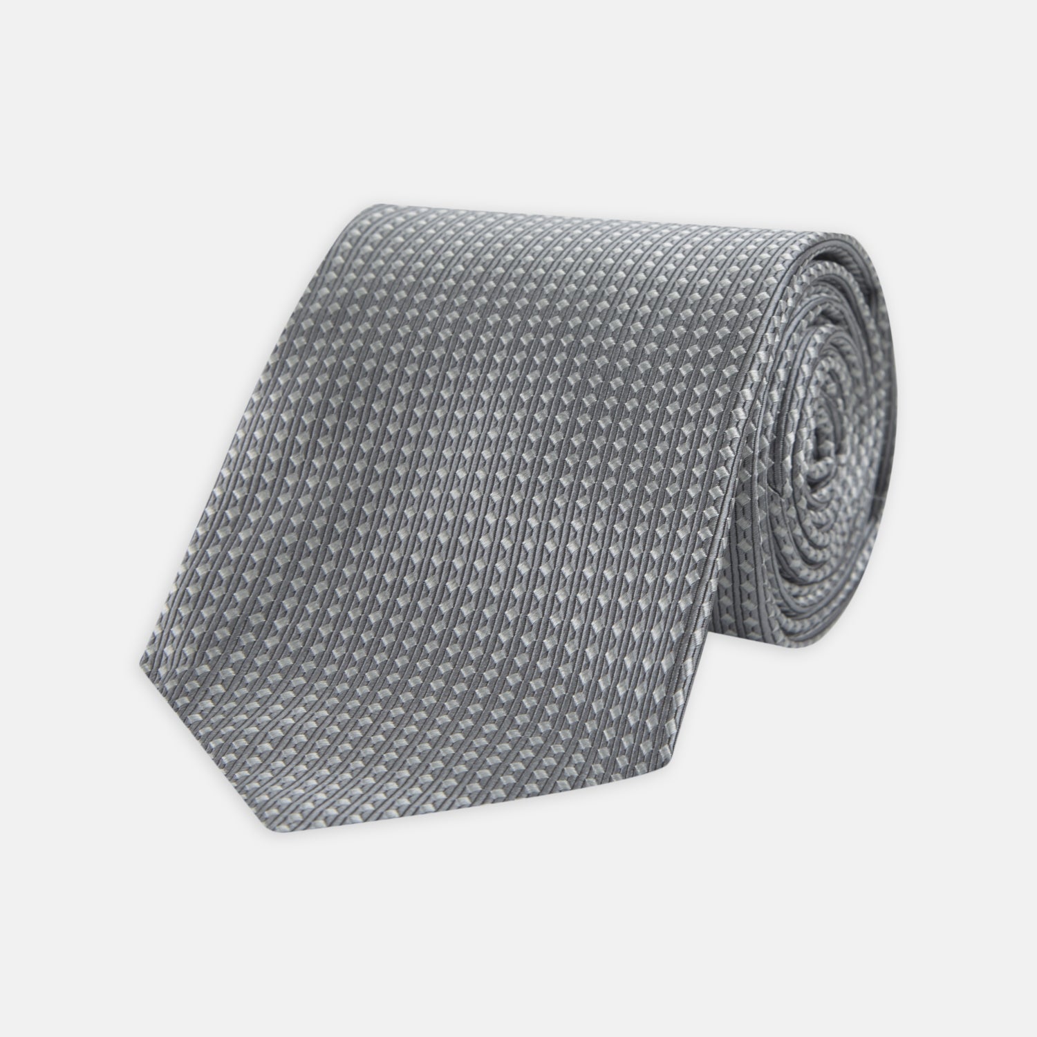 View 1 of product The Turnbull & Asser Grey and White Diamond Silk Tie, featuring a subtle textured pattern, is perfect for pairing with an office shirt and is displayed against a white background.