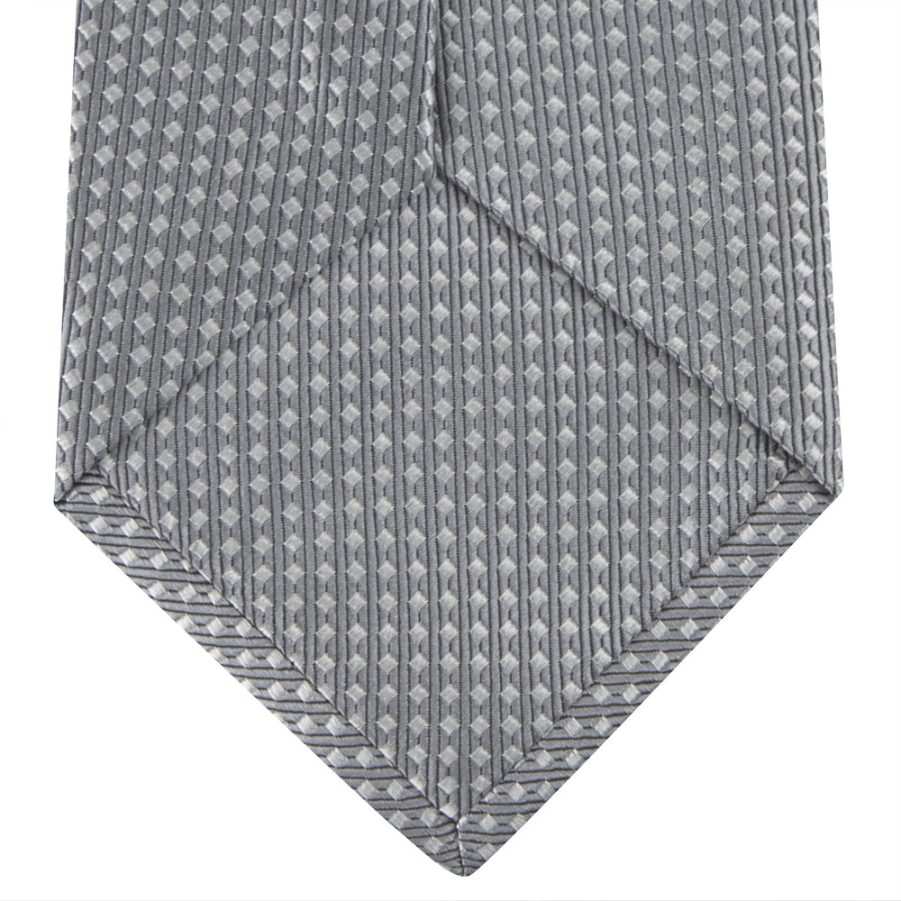 The Turnbull & Asser Grey and White Diamond Silk Tie, featuring a subtle textured pattern, is perfect for pairing with an office shirt and is displayed against a white background.