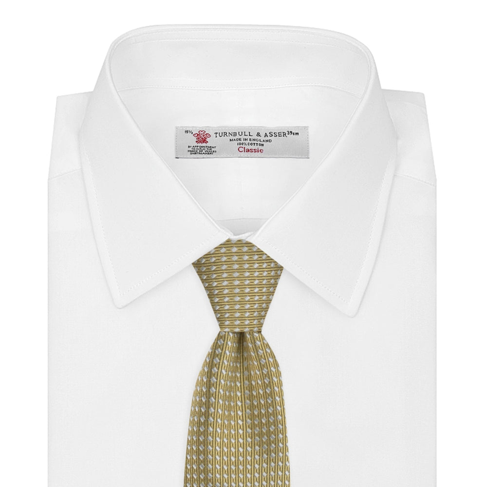 The Gold and White Diamond Silk Tie by Turnbull & Asser features a classic textured diagonal diamond pattern—ideal for elevating your favorite office shirt.