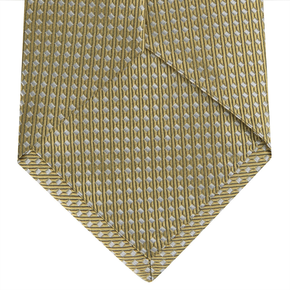 The Gold and White Diamond Silk Tie by Turnbull & Asser features a classic textured diagonal diamond pattern—ideal for elevating your favorite office shirt.