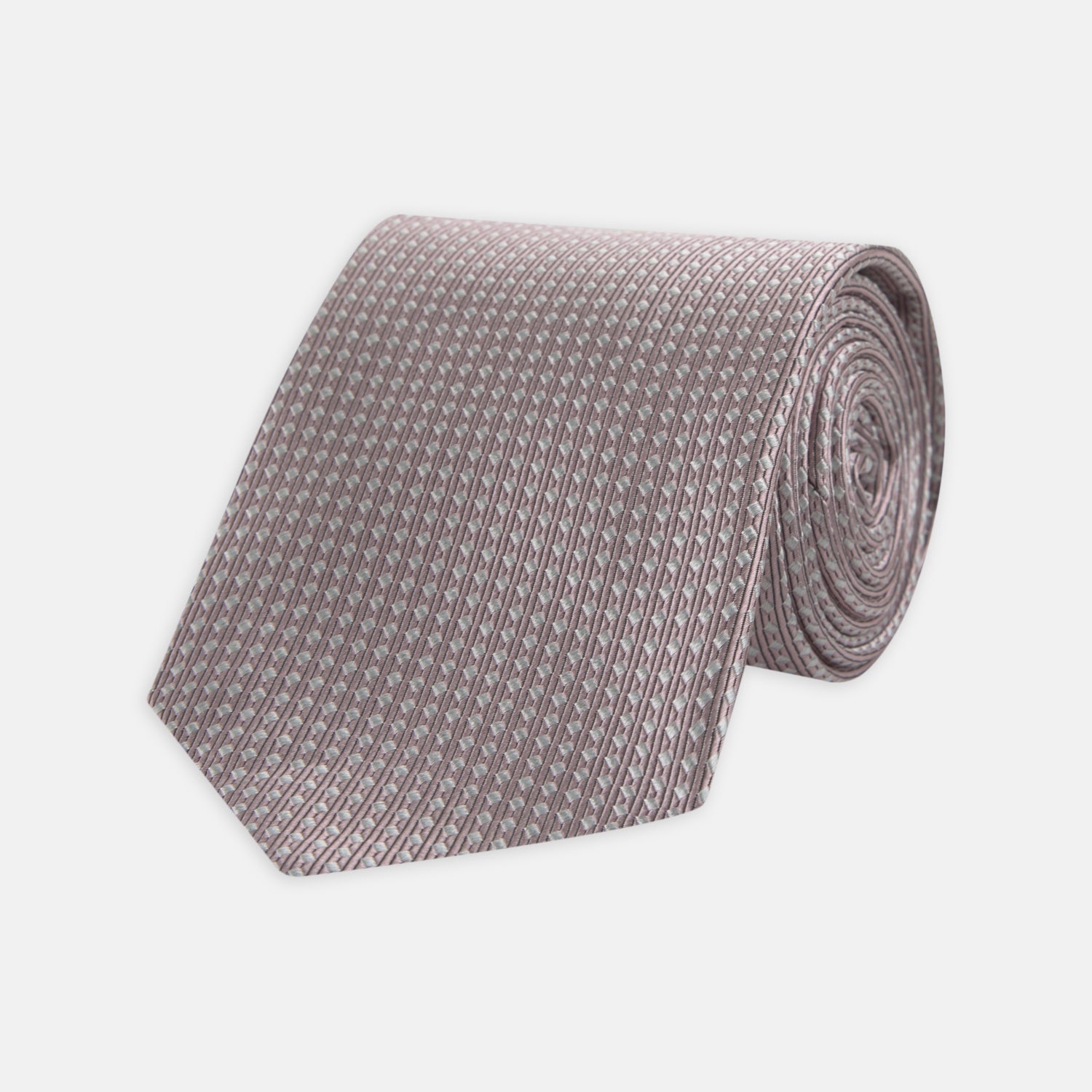 View 1 of product The Turnbull & Asser Rose and White Diamond Silk Tie, shown rolled on a white background, features a subtle diamond pattern—an elegant accessory to elevate any office shirt.